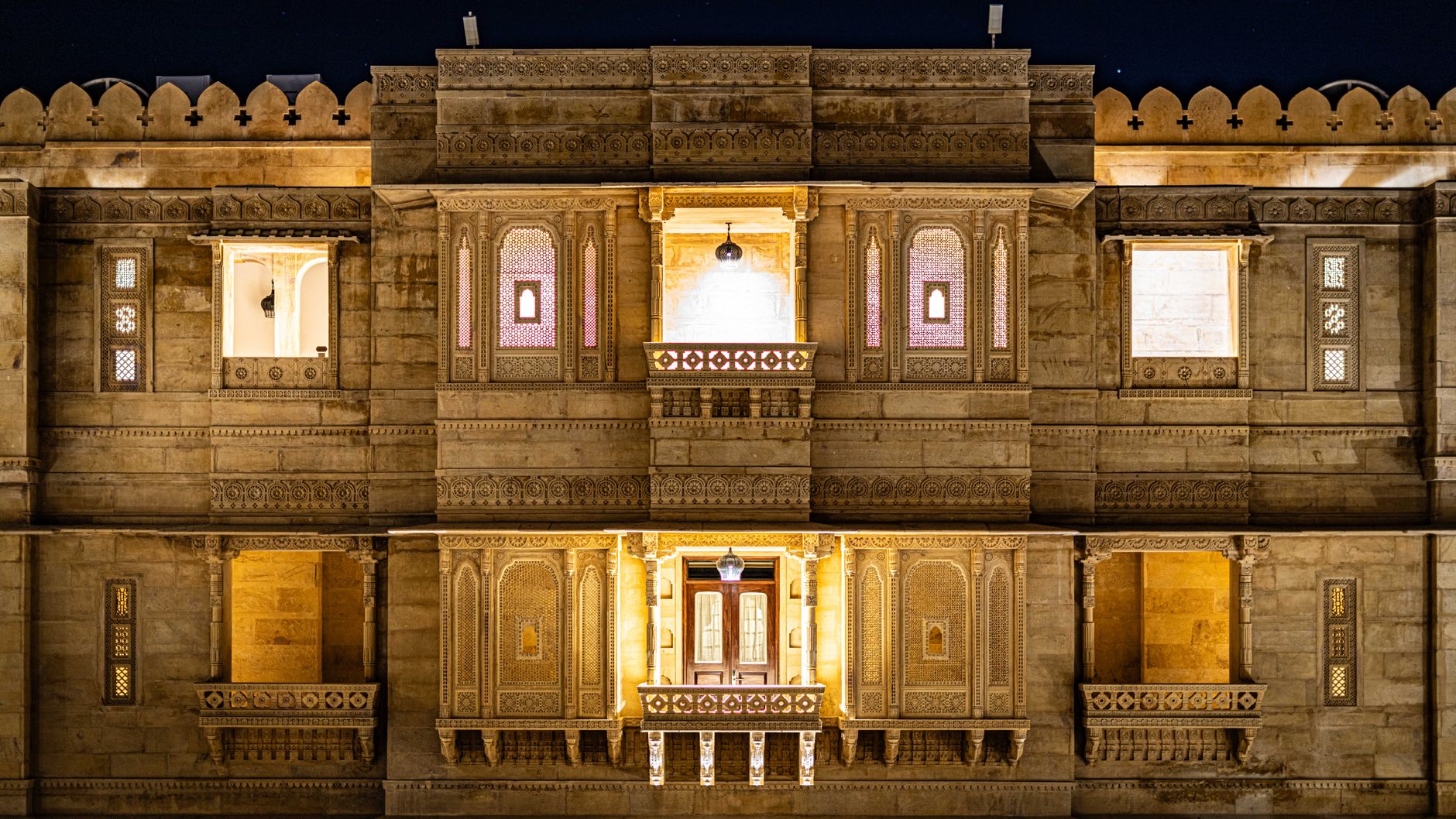 The lantern-lit courtyard of Krishna Palace at evening